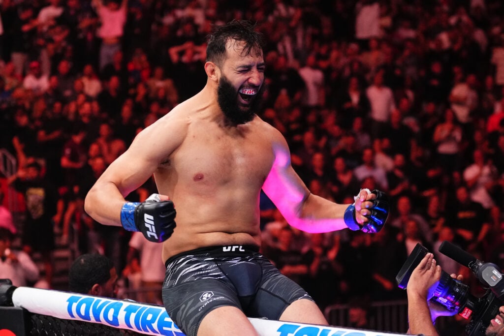 Dominick Reyes celebrates on the cage at UFC 314