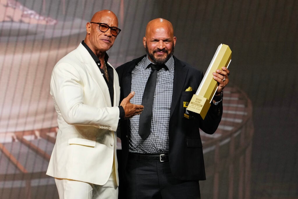 Dwayne Johnson presents the UFC Hall of Fame trophy to Mark Kerr during the UFC Hall of Fame Class of 2025 Induction Ceremony