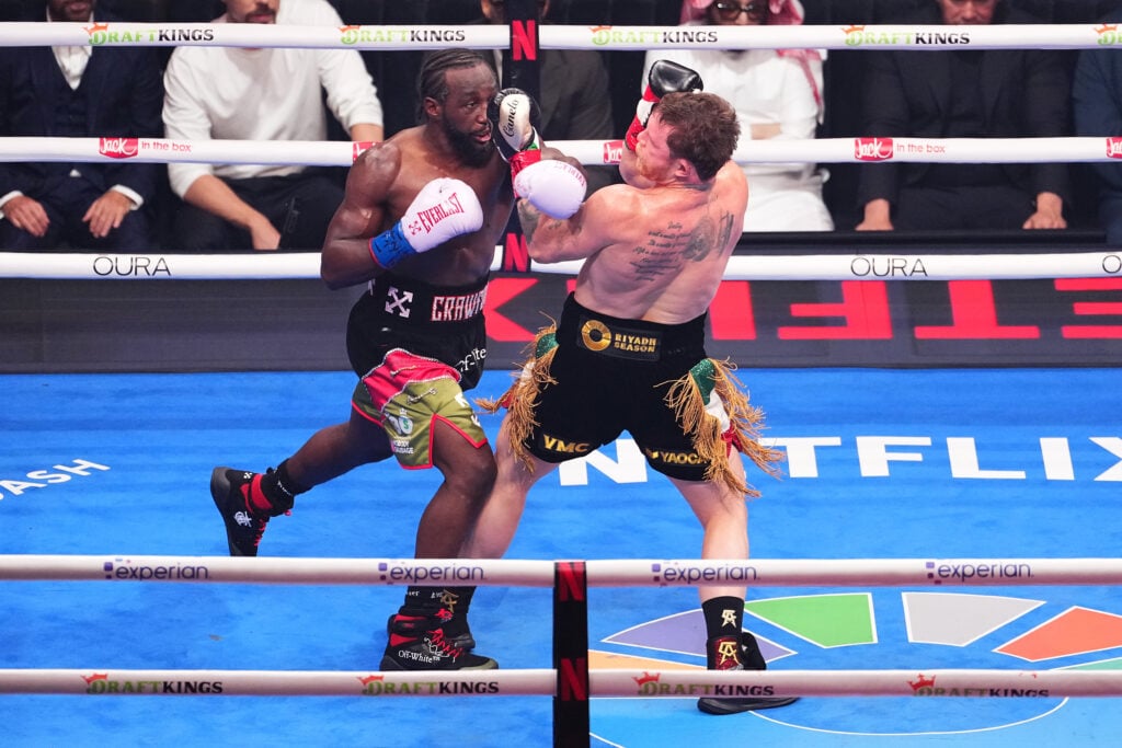 Terence Crawford and Canelo Alvarez punch each other during their boxing match