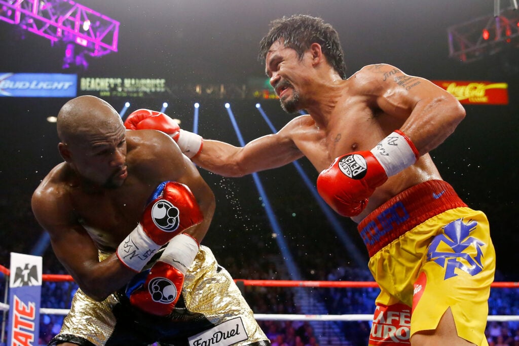 Manny Pacquiao throws a punch at Floyd Mayweather Jr. during their welterweight unification title fight in 2015