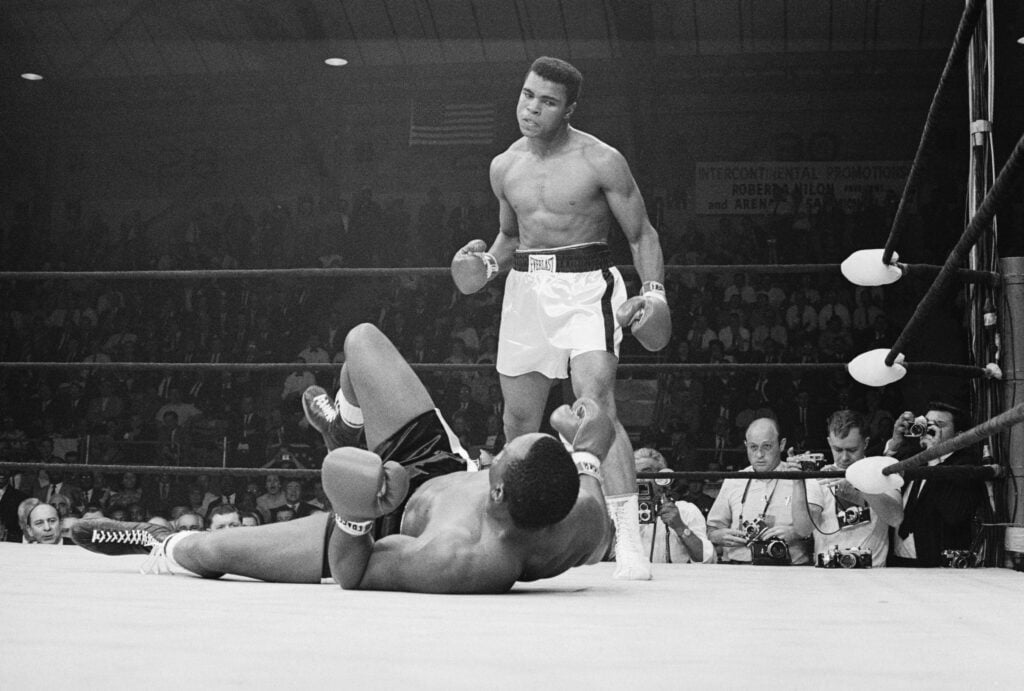 Muhammad Ali stands over Sonny Liston