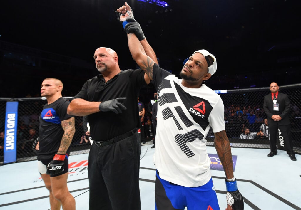 Michael Johnson has his hand raised after beating Dustin Poirier