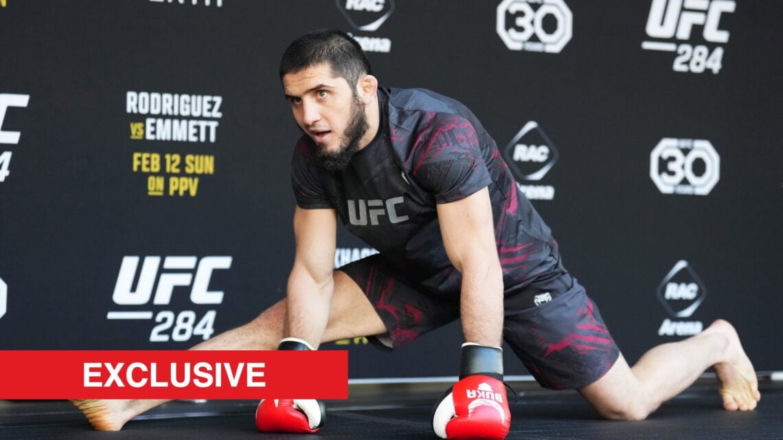 Islam Makhachev stretching at a UFC open workout