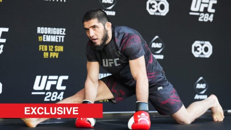 Islam Makhachev stretching at a UFC open workout