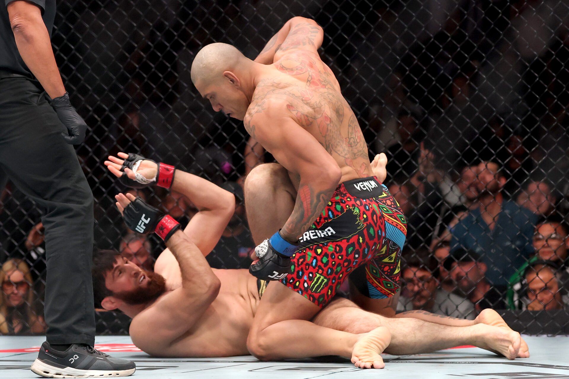 Alex Pereira lines up a punch after flooring Magomed Ankalaev at UFC 320
