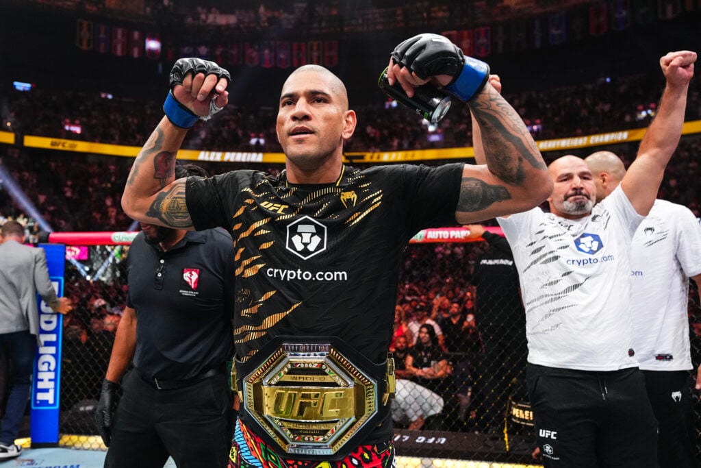Alex Pereira poses with his belt after winning at UFC 320