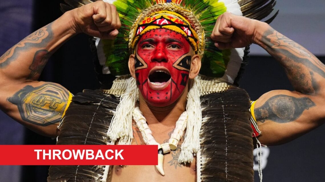 Alex Pereira poses on stage during the UFC 313 ceremonial weigh-ins, inset throwback banner