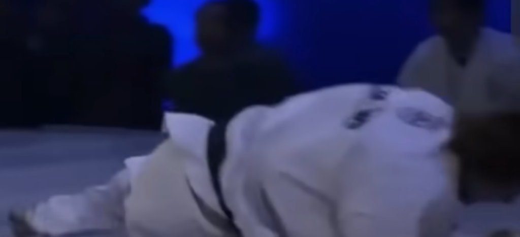 Karate practitioner lands outside after absorbing body kick