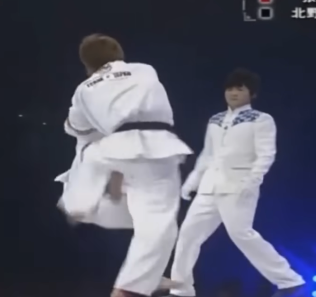 Tai Chi practitioner rolls to complete a throw