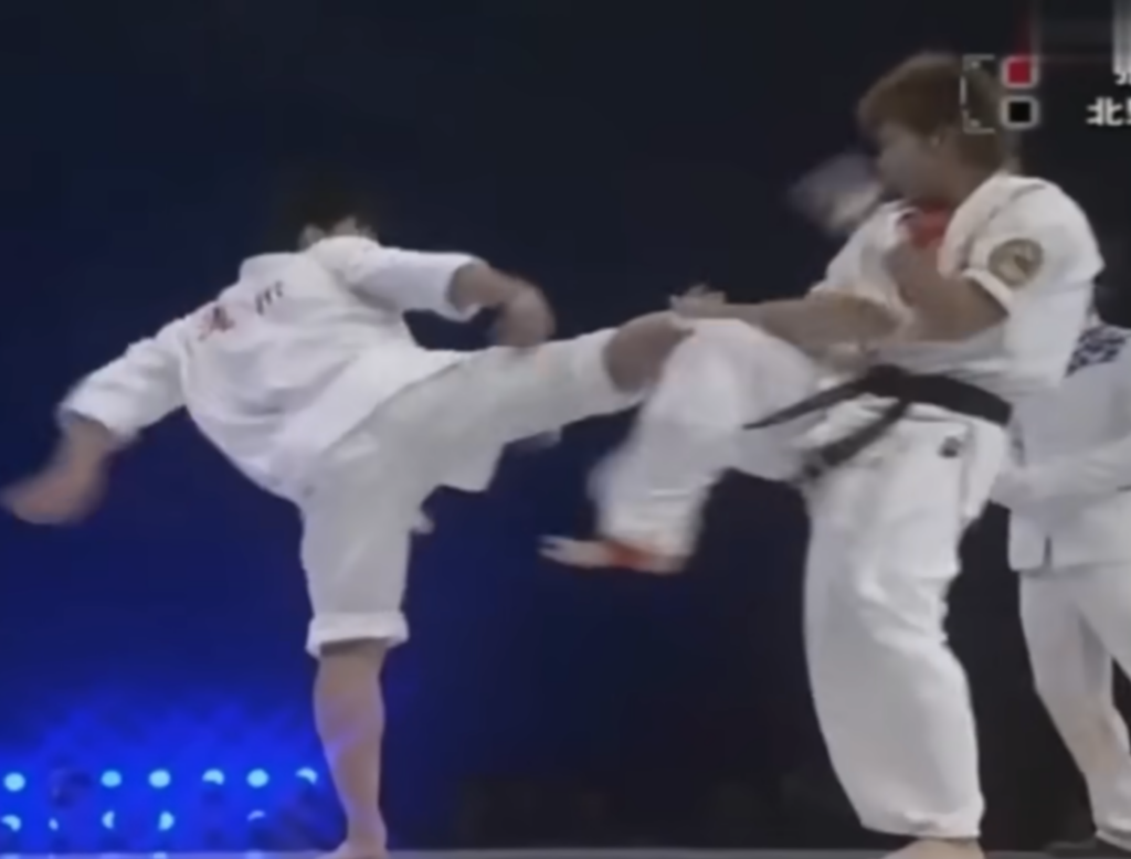 Tai Chi practitioner throws another side kick