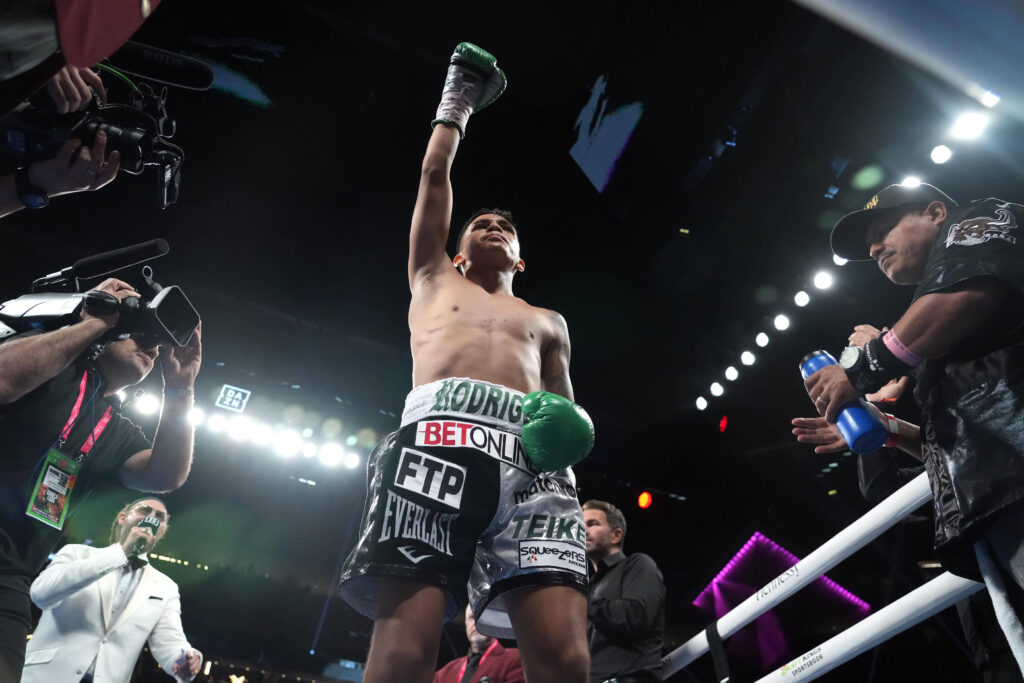 Bam Rodriguez (silver black trunks) and Israel Gonzalez (white trunks) box during their WBC super fly championship boxing bout at T-Mobile Arena.