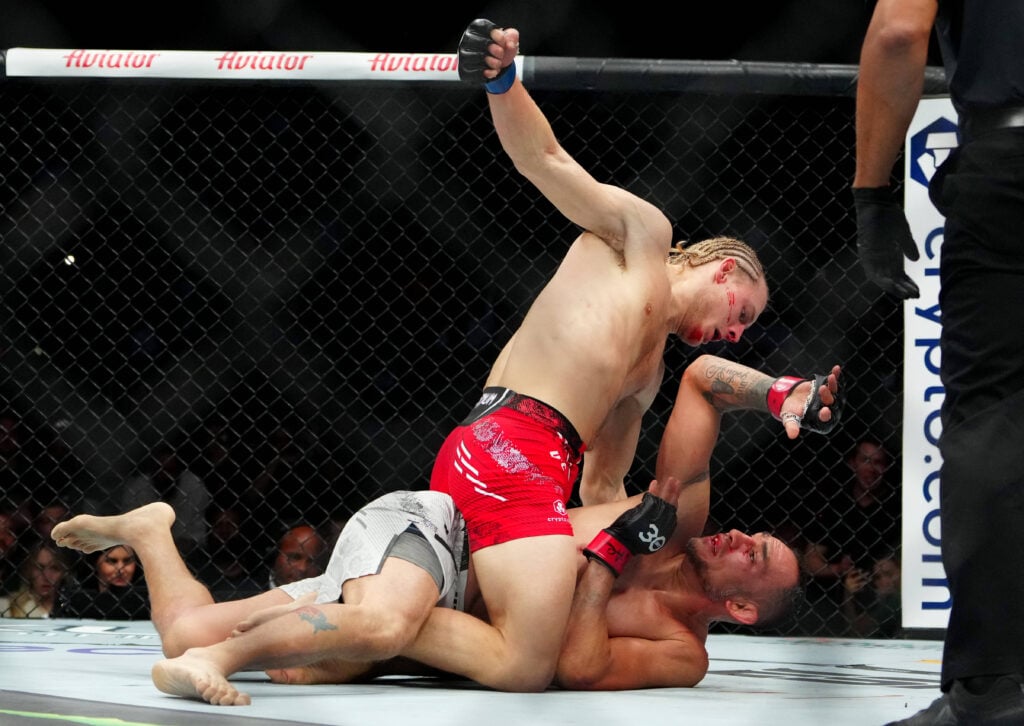 Tony Ferguson (red gloves) fights Paddy Pimblett (blue gloves) during UFC 296 at T-Mobile Arena.