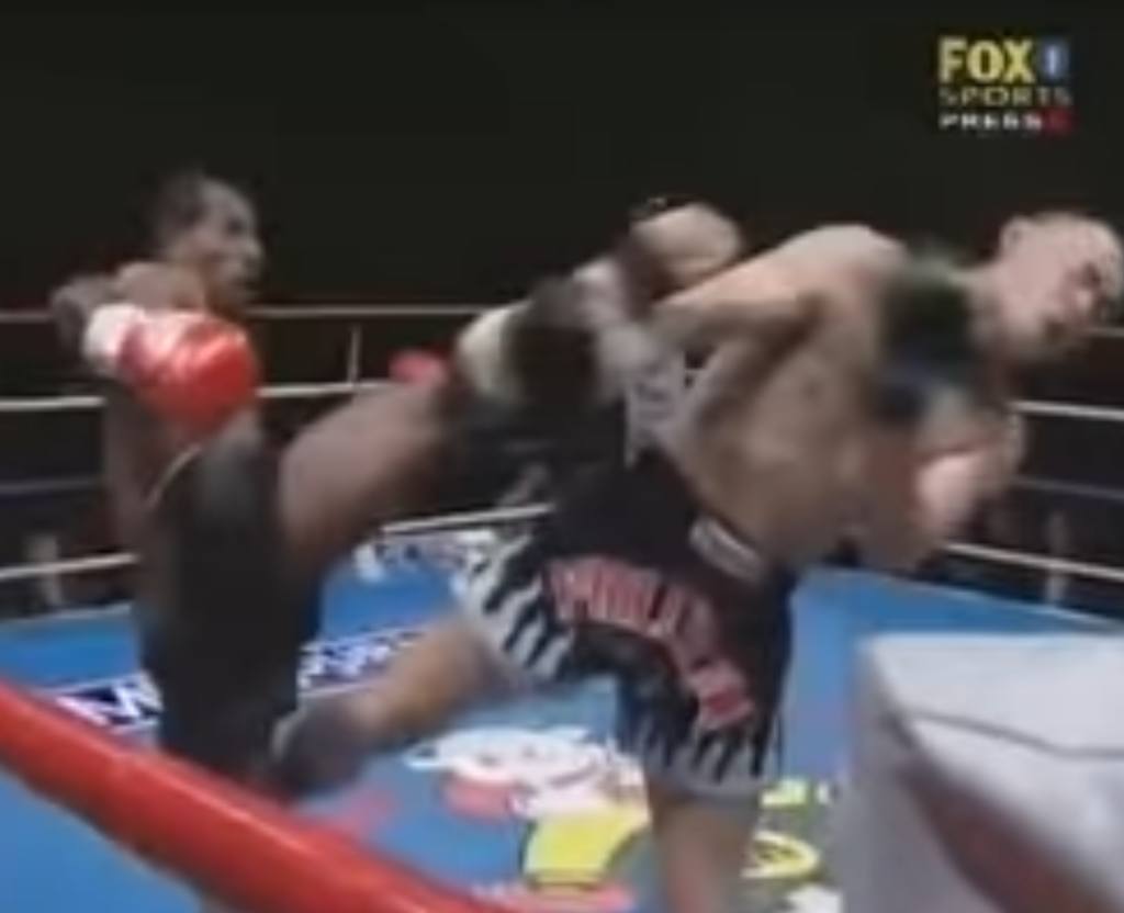 Kickboxer Stanley Nandex lands headkick with his right leg to his opponent.