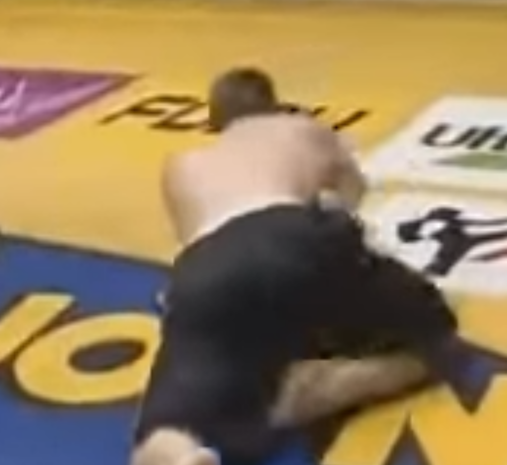 Kickboxer Stanley Nandex has dropped his opponent with a kick, leaving him crawling on the canvas.