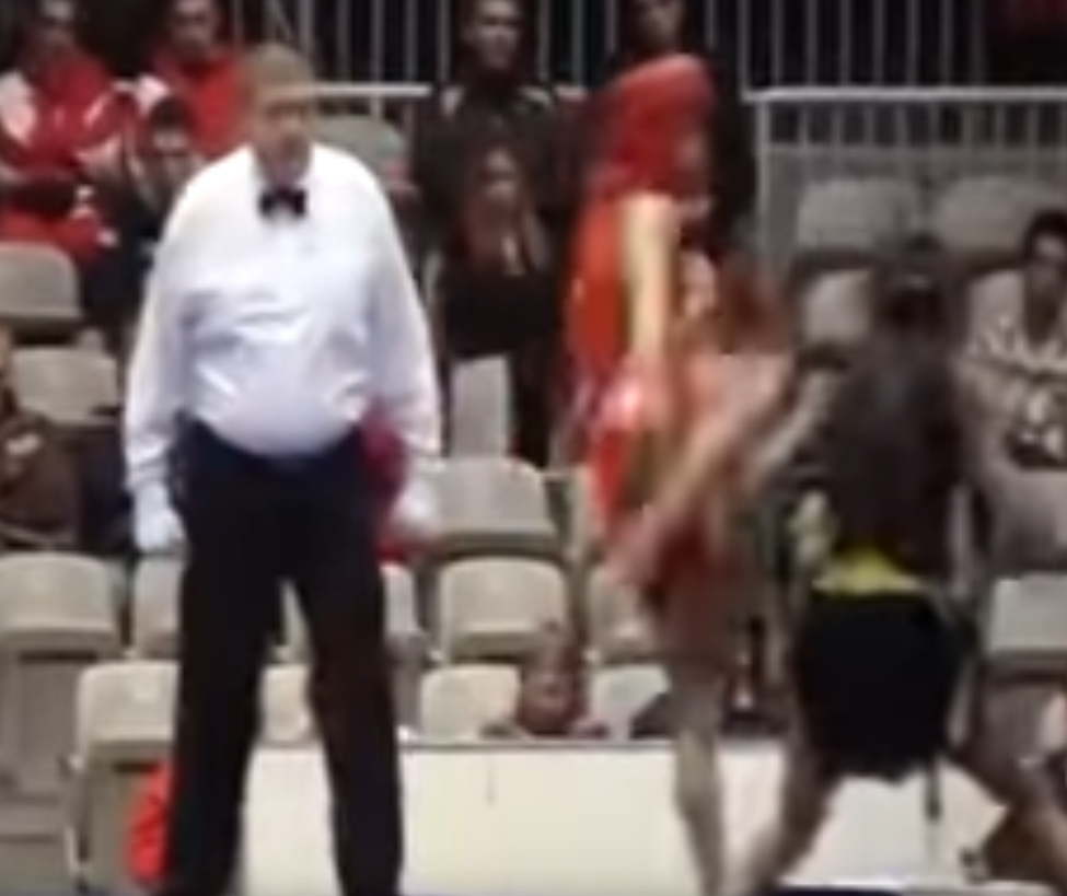 Sanshou competitor lifts leg for headkick.