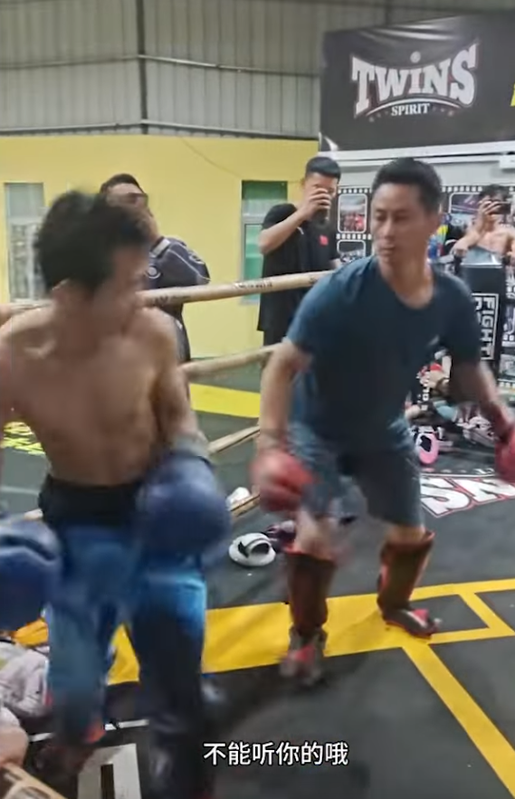 Kung Fu master prepares as opponent winds up a big punch